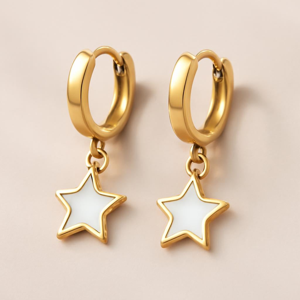A close-up shot of the luxury gold-plated white star huggie earrings, highlighting the sleek white stainless steel star charms against a soft, neutral background with gentle lighting to emphasize their shine and elegance.