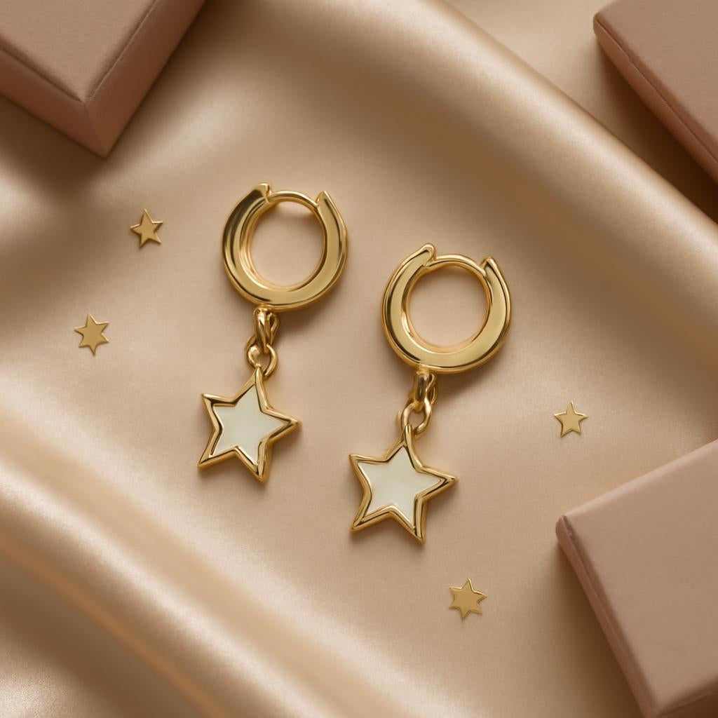 An artistic flat lay of the earrings placed on a luxurious fabric surface, surrounded by subtle decorative elements like tiny stars or jewelry boxes, emphasizing their sophisticated and celestial vibe.